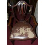 An early 20th century mahogany Hepplewhite style elbow chair, with tan leather upholstered stuffover