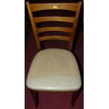 A set of six 1960s Stag beech slatback dining chairs, having vinyl pad seats