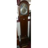 An early 20th century mahogany grandmother clock, the arched brass and silvered dial with