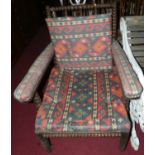 A Victorian bobbin turned oak armchair, having cushioned upholstery to webbed seat, width 70cm