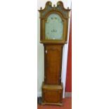 An early 19th century oak and mahogany crossbanded longcase clock, having a painted arched dial,