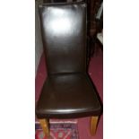 A set of four modern light oak framed and chocolate brown leather upholstered dining chairs (some