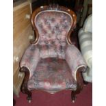 A mid-Victorian floral carved mahogany show frame gentleman's armchair, with buttoned kilim effect