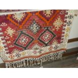 A Persian woollen red ground Kilim rug, having flat weave tasselled endsCondition report: 170 x