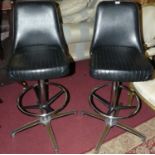 A pair of 1970s Chromcraft black leather and chrome framed swivel breakfast bar stoolsCondition