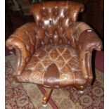 A tan leather buttoned and studded scroll swivel desk chair (for reupholstery), width 79cm