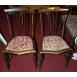 A pair of early 20th century stained beech stick back bedroom chairs