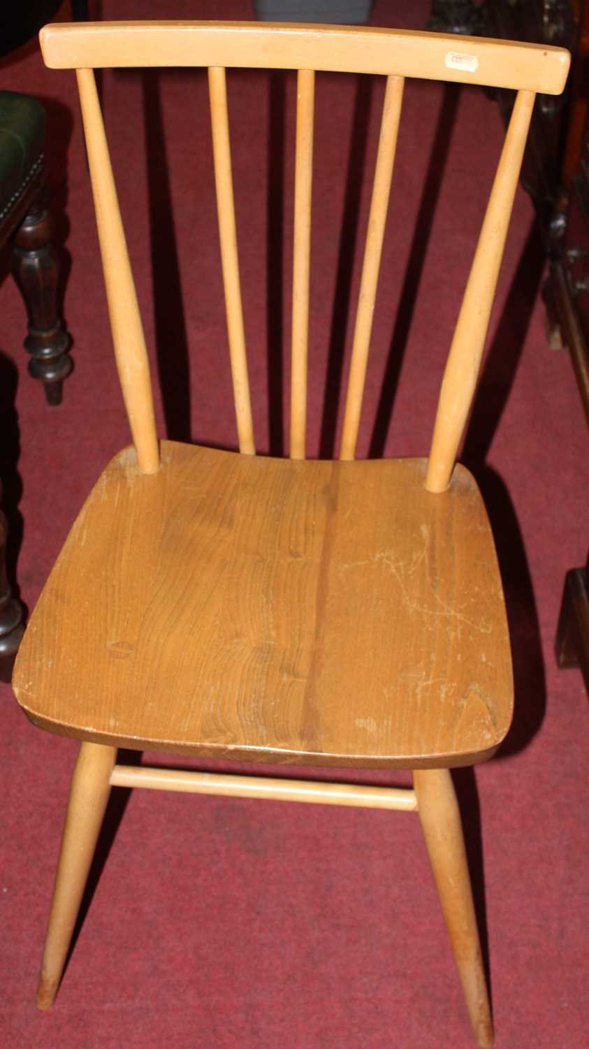 A pair of Ercol elm seat and beechwood stickback dining chairs