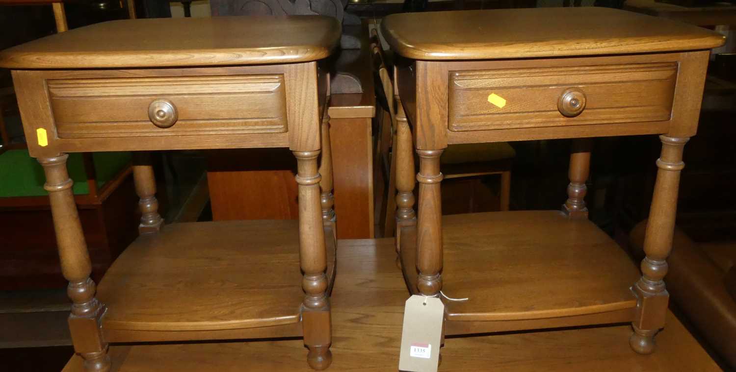 A pair of Ercol mid colour elm single drawer two-tier occasional tables, width 46cm
