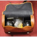 A vintage bowls set, housed in a leather carry case