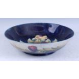 A large Moorcroft Pansy pattern footed circular fruit bowl, of raised form, underglaze painted and
