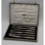 A set of six George VI tea knives, having steel blades and silver mounted handles, in fitted case