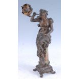 A French Art Nouveau spelter and onyx table lamp, modelled in the form of a seated maiden issuing