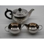 A George V silver bachelors three-piece tea service, of squat circular form, 22.7oz