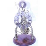 A Victorian brass skeleton cathedral clock, the pierced silvered dial with Roman numerals having a