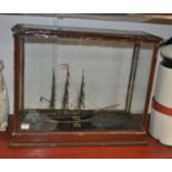 A scratch built model of a clipper having three masts and full rigging on naturalistic base within