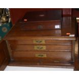 An Edwardian oak cutlery canteen (lacking contents), having recessed brass handles, the panelled