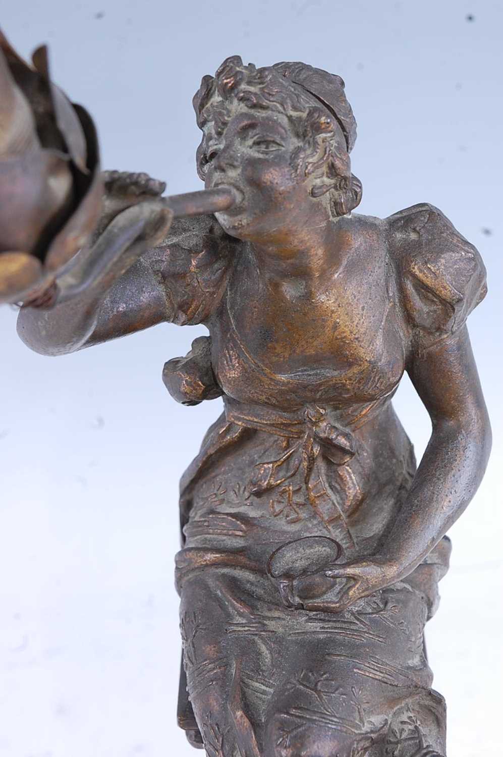 A French Art Nouveau spelter and onyx table lamp, modelled in the form of a seated maiden issuing - Image 3 of 5