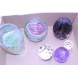 A collection of six glass paperweights to include Caithness