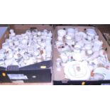 Two boxes of crested cabinet china, to include an Eglinton China model of a longcase clock with