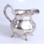 A mid-19th century Russian silver cream jug, of lobed baluster form, having C-scroll handle and