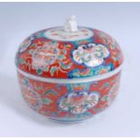 A Japanese Meiji period Kenjo Imari bowl and cover, the lid with shisa finial, enamel decorated with