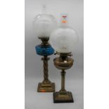 An early 20th century oil lamp, having opalescent globular shade, brass font, on brass column and