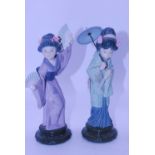 A Lladro Spanish porcelain figure modelled as a geisha girl in standing pose with parasol above