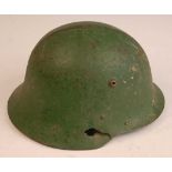 A Bulgarian M36 steel helmet, having a leather liner and chin strap, with combat damage.