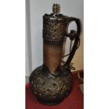 A 1970s West German pottery table lamp, on a mottled brown ground with pierced and relief