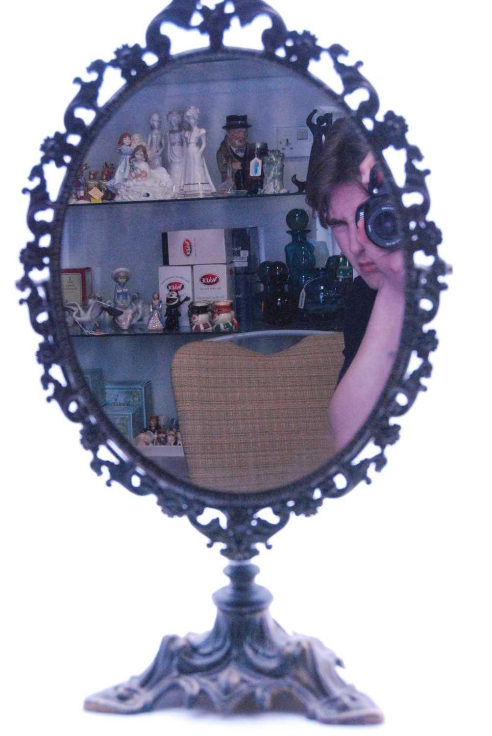 A Victorian style dressing table mirror, the oval mirror plate within a pierced foliate surround