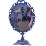 A Victorian style dressing table mirror, the oval mirror plate within a pierced foliate surround