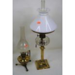 An early 20th century oil lamp with chimney, having an opalescent glass shade above a clear glass