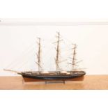 A wooden kit-built static display model of a 3 mast 19th-century model boat, comprising black