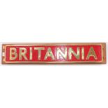 A reproduction brass "Britannia" locomotive nameplate, red ground example, housed on wooden board,