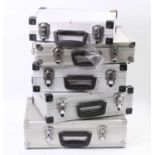 Five aluminium carrying/storage cases, lined, with locks and keys: three 15” x 10 ½”; one each 17” x