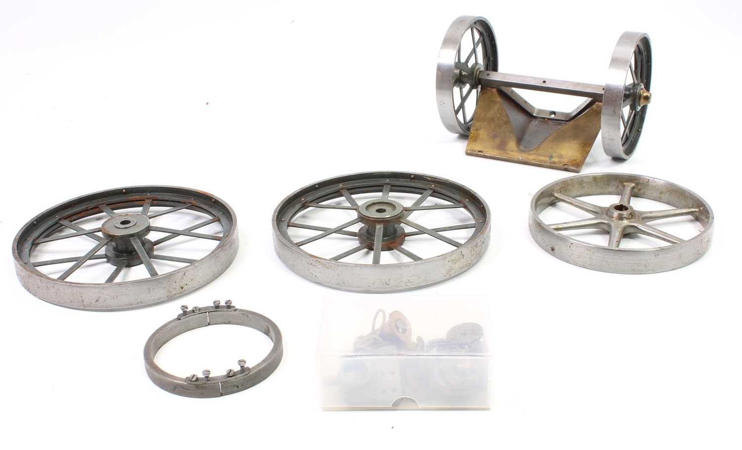 Box containing a collection of live steam portable engine parts, to include 4 spoked wheels,