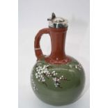 An early 20th century Devon Pottery jug, having slender neck with loop handle and bulbous lower