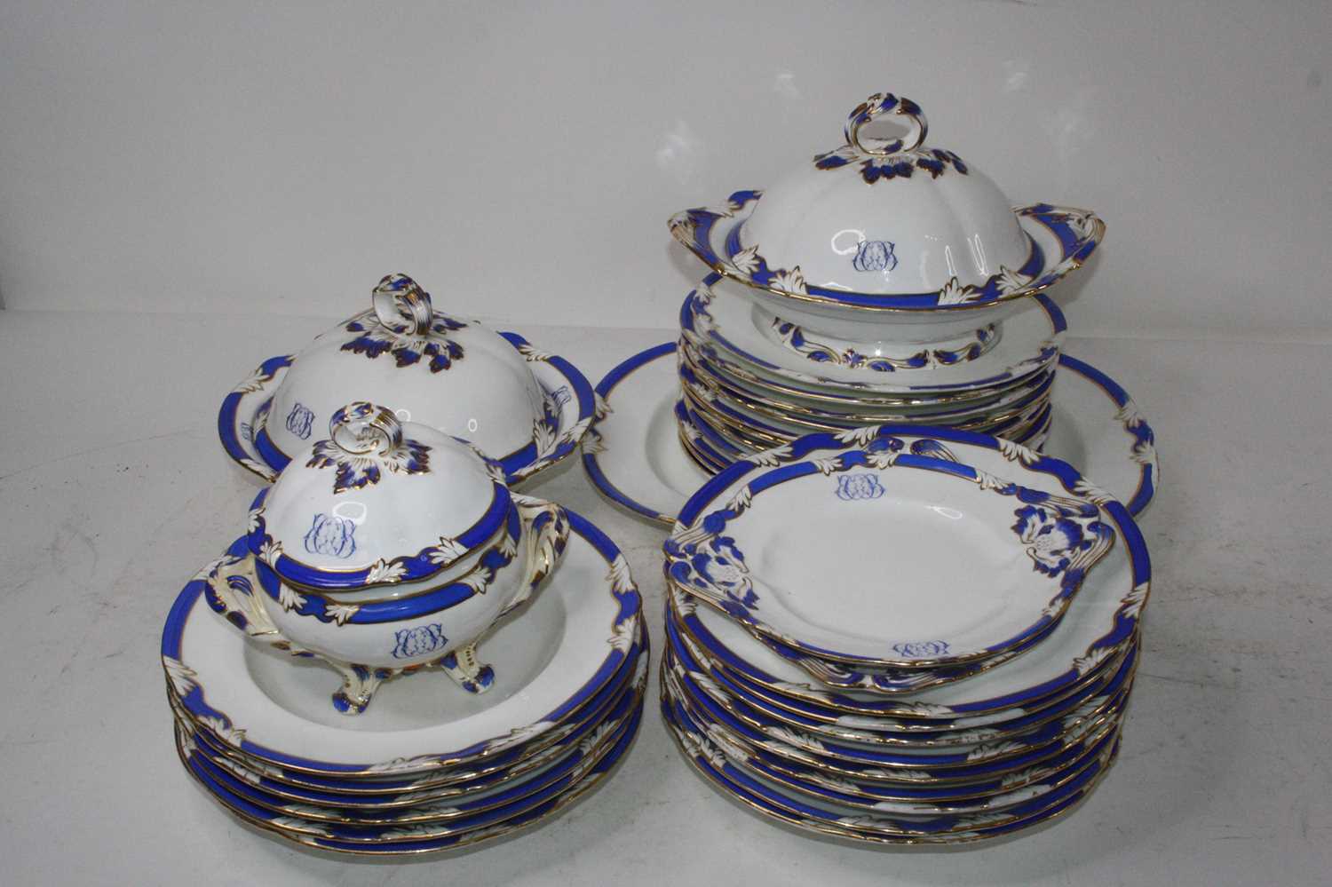 A Victorian Daniell part dinner service, on a white ground with blue borders and heightened in gilt,