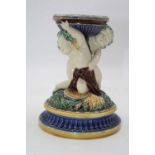 A Victorian Minton jardiniere stand, the circular platform supported by two cherubs, on a moulded