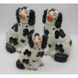 A set of three Staffordshire pottery model of spaniels, largest 25cmAll are cracked