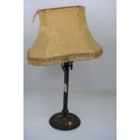 A 20th century neo-classical style brass table lamp, having gold silk shade, 59cm high including the