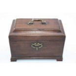 A George III mahogany tea caddy, the cavetto moulded lid lifting to reveal three compartments,