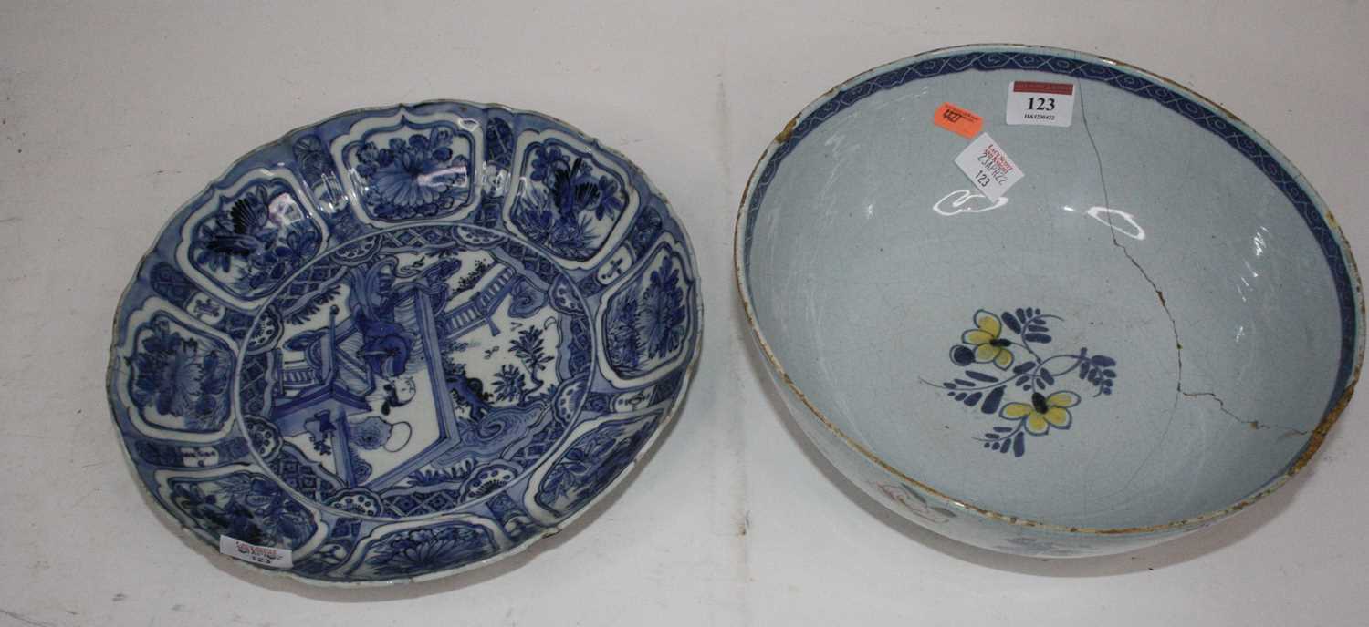 A 19th century Delft bowl on a pale blue ground decorated with flowers, dia. 26cm, together with a
