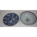 A 19th century Delft bowl on a pale blue ground decorated with flowers, dia. 26cm, together with a