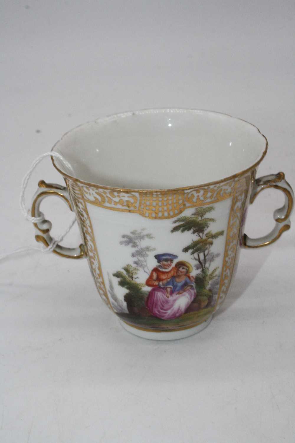 A 19th century Berlin porcelain trembleuse, the twin handled cup decorated with opposing reserves of - Image 3 of 4