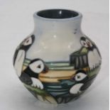 A small Moorcroft vase of squat circular form, tubeline decorated in the Puffin pattern, having a