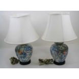 A pair of 20th century porcelain table lamps, each enamel decorated with birds amongst flowers, 52cm