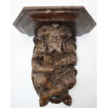 A 20th century figural carved wall bracket in the form of a court jester, 29cm high