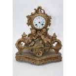 A 19th century French gilt metal mantel clock, the enamel dial showing Roman numerals, having